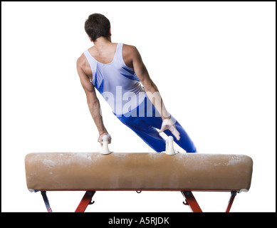 Male gymnast performing on vaulting horse Stock Photo