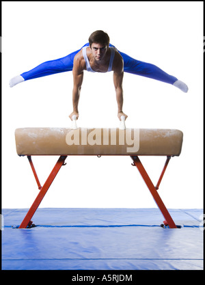 Male gymnast performing on vaulting horse Stock Photo