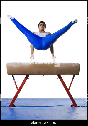 Male gymnast performing on vaulting horse Stock Photo