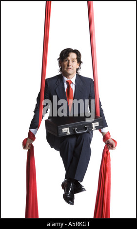 Businessman tangled in red drapes Stock Photo