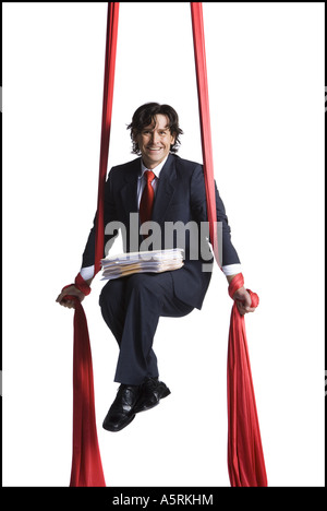 Businessman tangled in red drapes Stock Photo