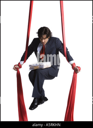 Businessman tangled in red drapes Stock Photo