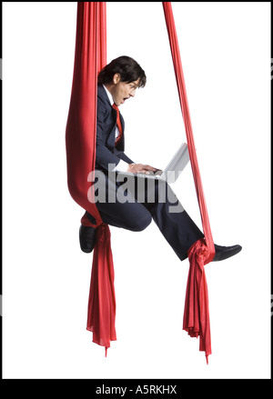 Businessman tangled in red drapes Stock Photo