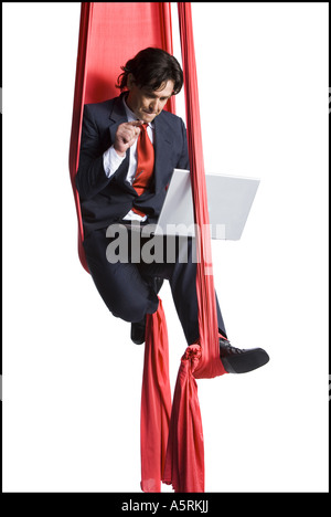 Businessman tangled in red drapes Stock Photo