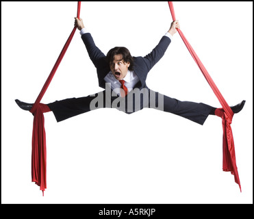 Businessman tangled in red drapes Stock Photo