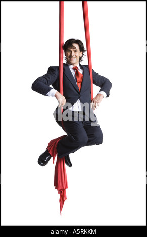 Businessman tangled in red drapes Stock Photo