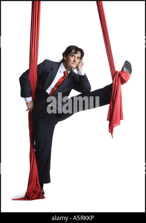 Businessman tangled in red drapes Stock Photo