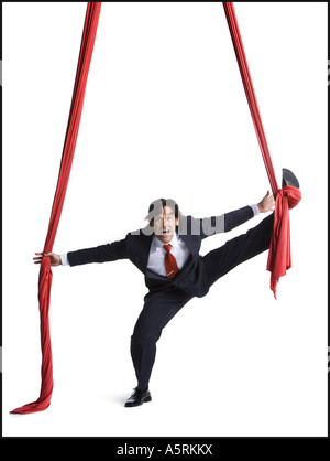 Businessman tangled in red drapes Stock Photo