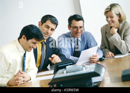 Business colleagues sitting in meeting, smiling Stock Photo