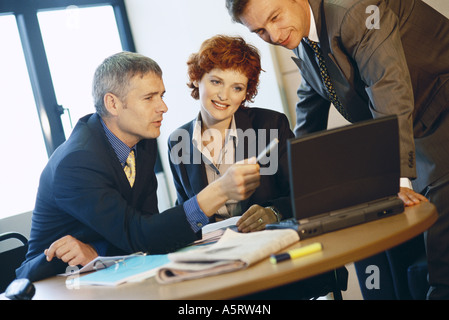 Business colleagues using laptop Stock Photo