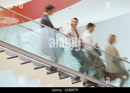 Business executives going down staircase Stock Photo