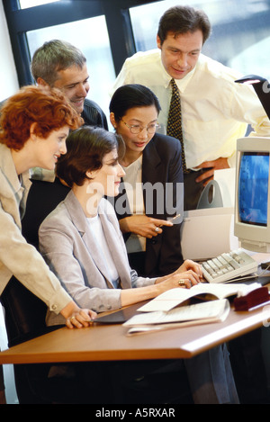 Group of businesspeople working together at desk Stock Photo