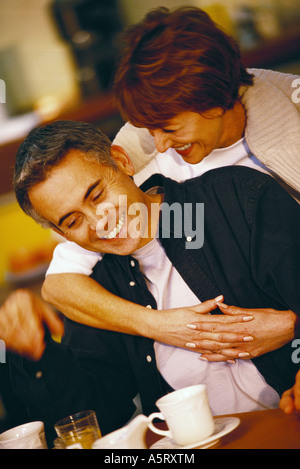 Senior couple, woman embracing man from behind Stock Photo