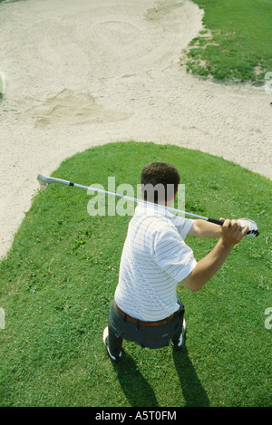 Golfer swinging, high angle view Stock Photo
