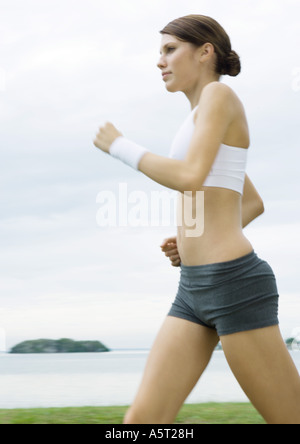 Young woman power walking outdoors Stock Photo