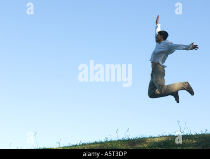 Man jumping in the air, arms out Stock Photo