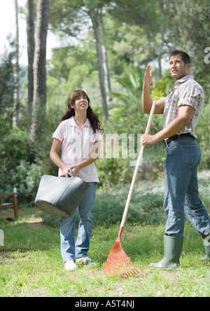 Man and teenage girl doing yard work Stock Photo