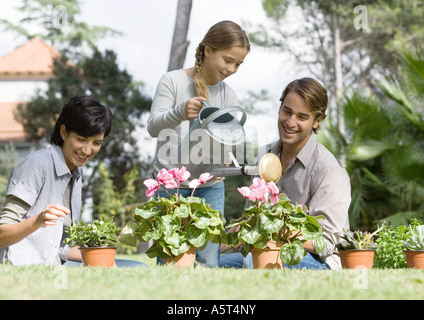 Family tending potted plants Stock Photo