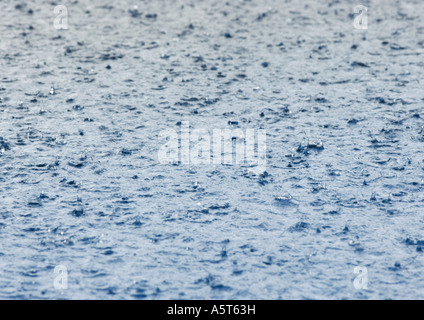 Rain falling on surface of water Stock Photo