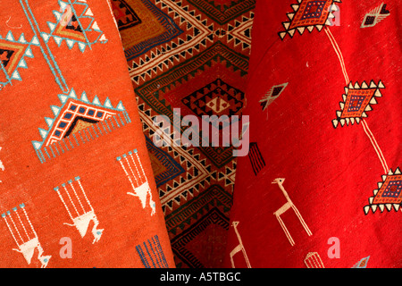 Horizontal close up detail of bright coloured rugs and carpets for sale in Douz market, Tunisia, North Africa Stock Photo