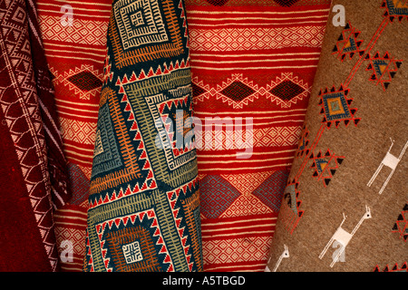 Horizontal close up detail of bright coloured rugs and carpets for sale in Douz market, Tunisia, North Africa Stock Photo