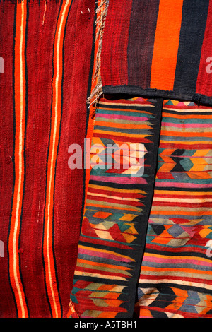 Horizontal close up detail of bright coloured rugs and soft furnishings in Douz market, Tunisia, North Africa Stock Photo