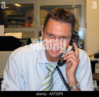Friendly smiling Business man using Telephone Head and Shoulders Utrecht The Netherlands Stock Photo