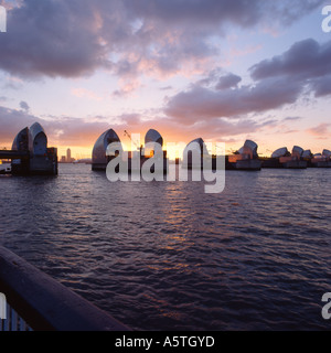 The Thames Barrier at Dusk with Canary Wharf. Stock Photo