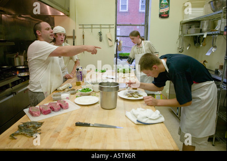 A chef and assistants cooking in a busy restaurant Canajoharie New York Montgomery County Stock Photo