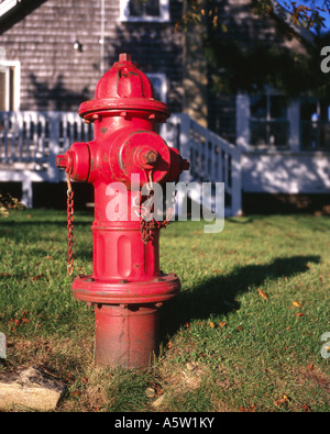 Red fire hydrant in the front garden of a clapboard house,Martha's Vineyard,Massachussetts,U.S.A. Stock Photo