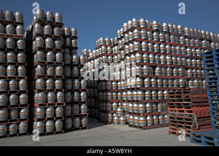 Barrels of beer stacked high on pallets Stock Photo