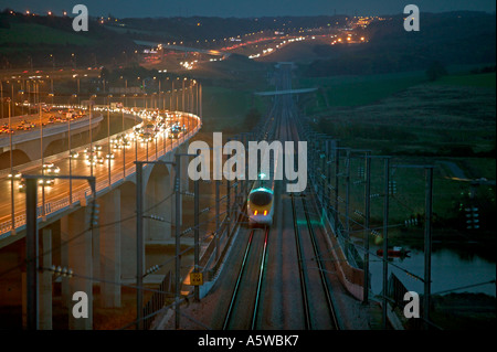 Eurostar train crossing the River Medway at night close to M2 Motorway on the High Speed One (Channel Tunnel Rail Link). Stock Photo