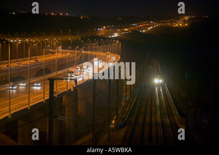 Eurostar train crossing the River Medway at night close to M2 Motorway on the High Speed One (Channel Tunnel Rail Link). Stock Photo