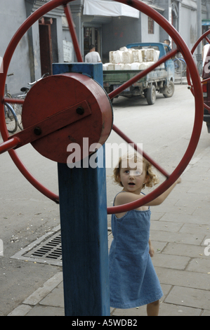 Little girl playing in an old hutong in Beijing, China. Stock Photo