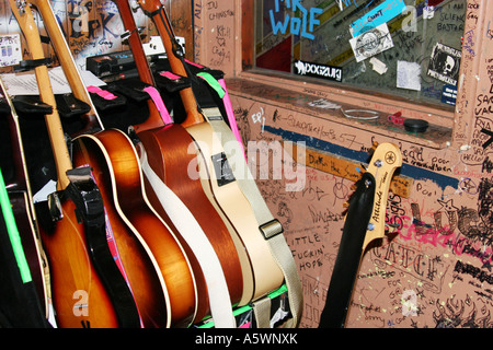 Stacked guitars in a graffiti-covered backstage room before a gig at a live music venue. Stock Photo