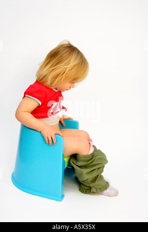 Toddler potty training in color on white background Stock Photo