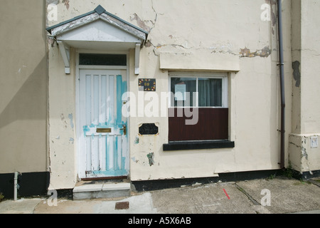 Faded paintwork and cracked facing on terraced house front Blaenavon South Wales UK Stock Photo