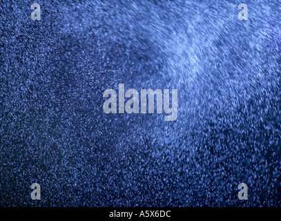ABSTRACT IMAGE OF BLUE PARTICLES SWIRLING IN TURBULENT AIR Stock Photo