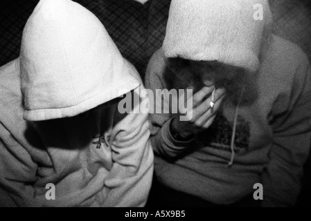 2 guys in hoodies smoking cannabis Stock Photo