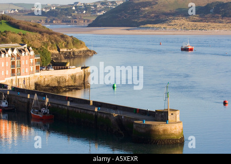 Harbour wall, fishing boats, quayside properties and Camel estuary.  Padstow. Cornwall. UK. Stock Photo