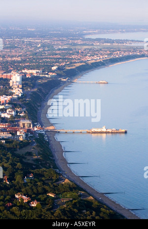 Aerial view. Evening sun shining on Bournemouth and Boscombe piers and cliff top hotels. Mist on the horizon. Dorset. UK.