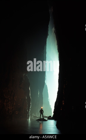A caver in a huge river passage in a cave in Sichuan province China Stock Photo