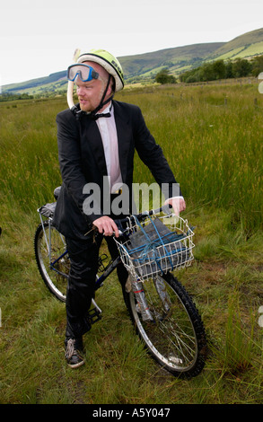 Competitor in annual World Mountain Bike Bog Snorkelling Championships Llanwrtyd Wells Powys wearing a dinner suit Wales UK Stock Photo