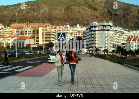 students with a backdrop of holiday and living accommadation Los Cristianos Tenerife Canary islands Spain Stock Photo