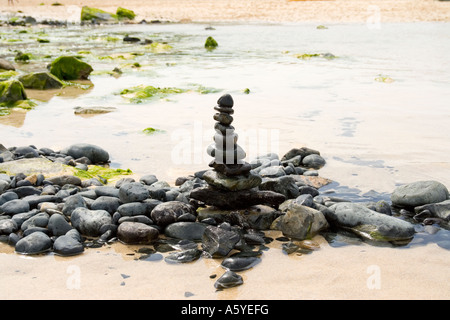 Small pile of balanced pebbles on beach Stock Photo