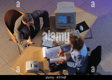 High angle view of two businesspeople discussing in office Stock Photo
