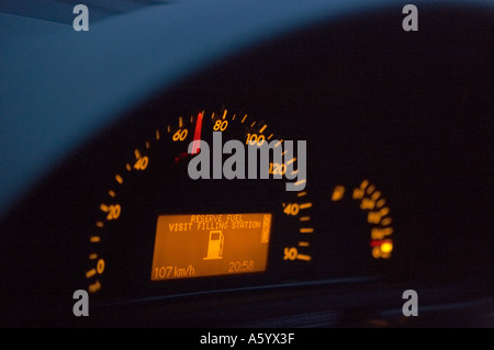 CAR DASHBOARD INSTRUMENTS SHOWING SPEEDOMETER AND LOW FUEL WARNING Stock Photo