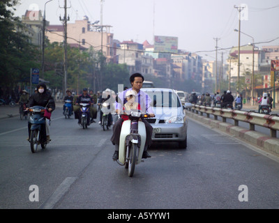 Child on scooter with father in rush hour traffic. Stock Photo