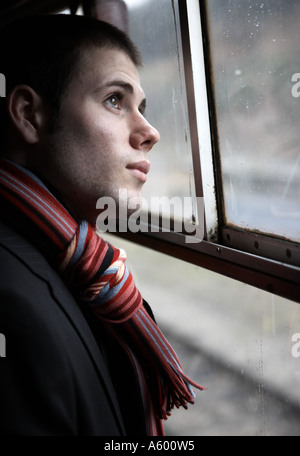 Young Business professional man looking through window Stock Photo