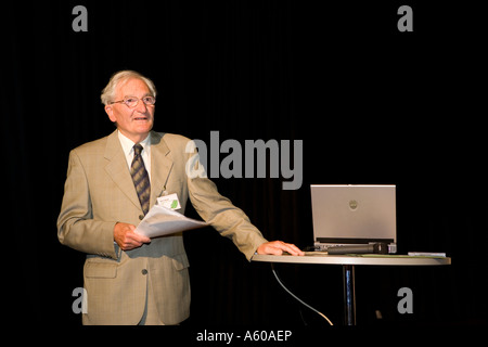 Speaker at a conference with a laptop used for a digital presentation Stock Photo
